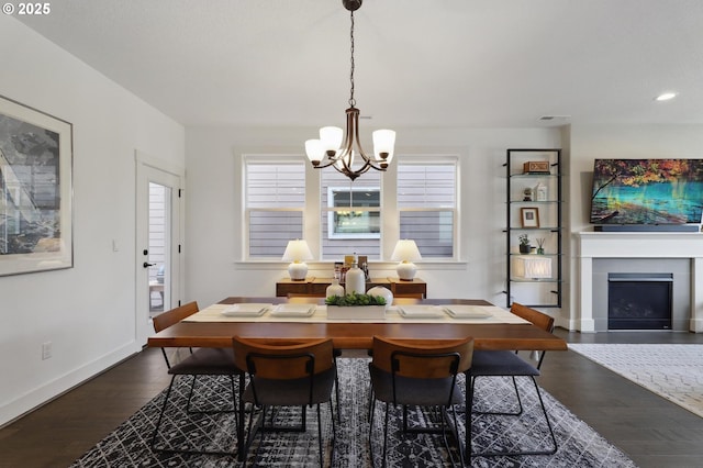 14878 NW Olive St, Portland, OR 97229 - dining area with a fireplace, baseboards, dark wood-style floors, a chandelier, and recessed lighting