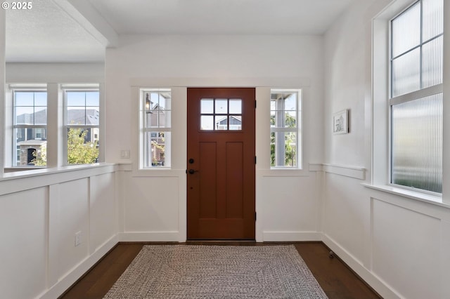 14878 NW Olive St, Portland, OR 97229 - foyer entrance with dark wood finished floors, a decorative wall, and wainscoting