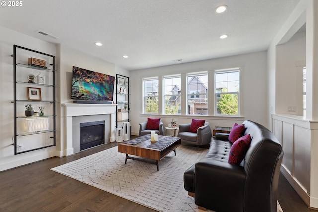 14878 NW Olive St, Portland, OR 97229 - living area with recessed lighting, visible vents, dark wood-style floors, and a fireplace