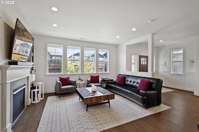 14878 NW Olive St, Portland, OR 97229 - living room with a glass covered fireplace, plenty of natural light, and dark wood-type flooring