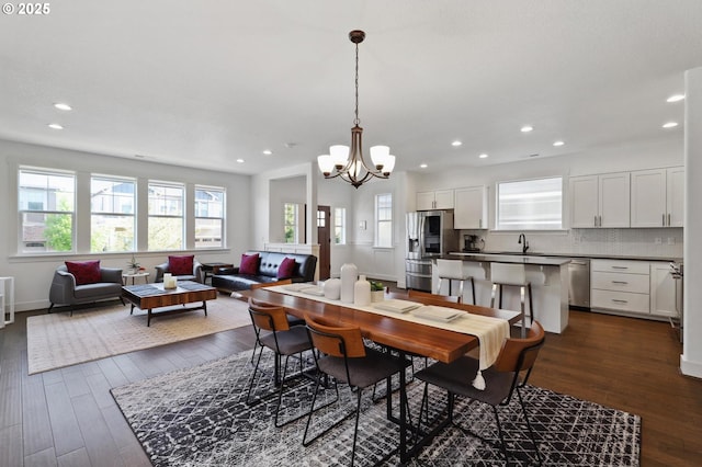 14878 NW Olive St, Portland, OR 97229 - dining room with baseboards, a notable chandelier, recessed lighting, and dark wood-type flooring