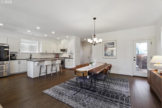 14878 NW Olive St, Portland, OR 97229 - dining area featuring an inviting chandelier, recessed lighting, dark wood finished floors, and plenty of natural light