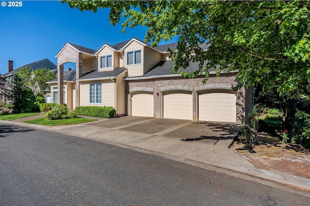 2525 NW 141st Pl, Portland, OR 97229 - view of front of house with driveway, an attached garage, and brick siding
