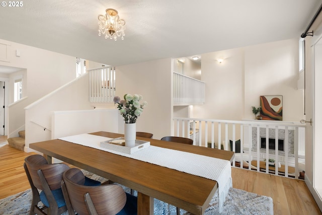 dining space featuring a chandelier and light wood-type flooring