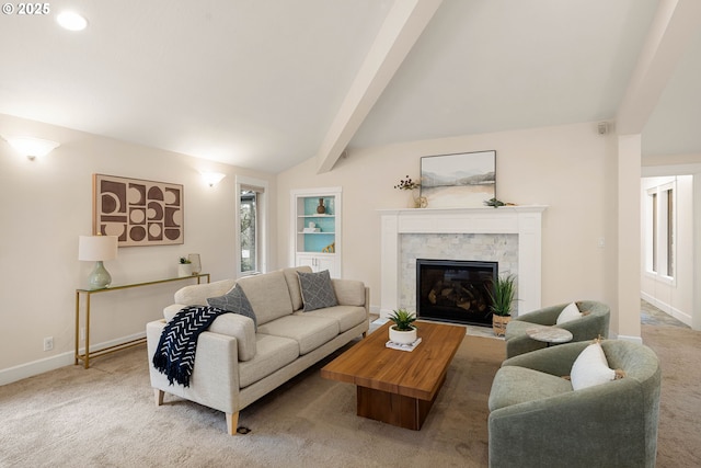 carpeted living room featuring lofted ceiling with beams