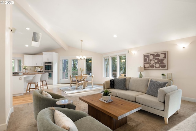 living room featuring lofted ceiling with beams, a notable chandelier, and light hardwood / wood-style floors