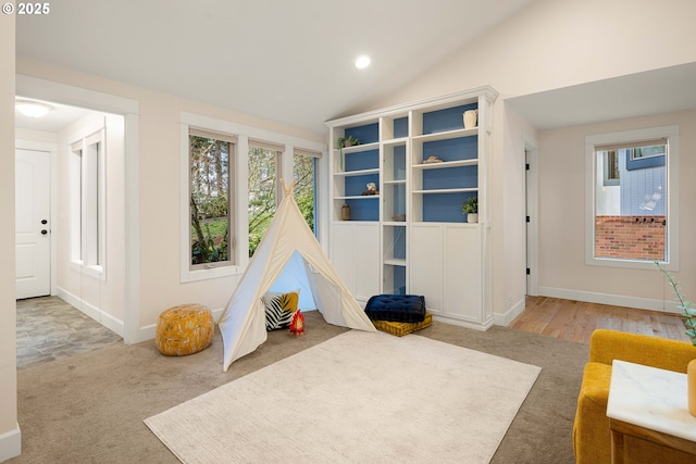 game room featuring vaulted ceiling and carpet flooring