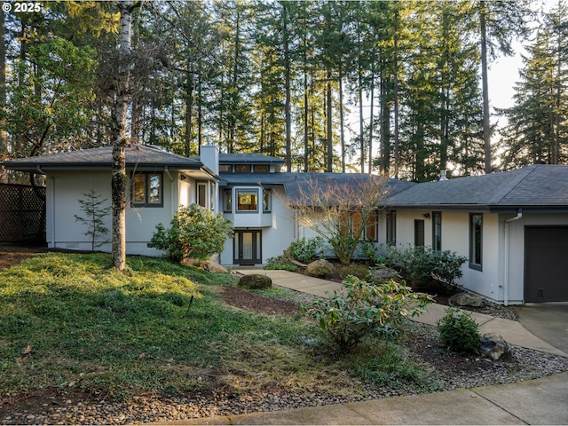 view of front of property with a garage and a front yard