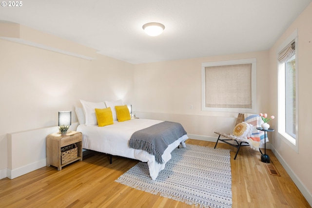 bedroom with hardwood / wood-style floors