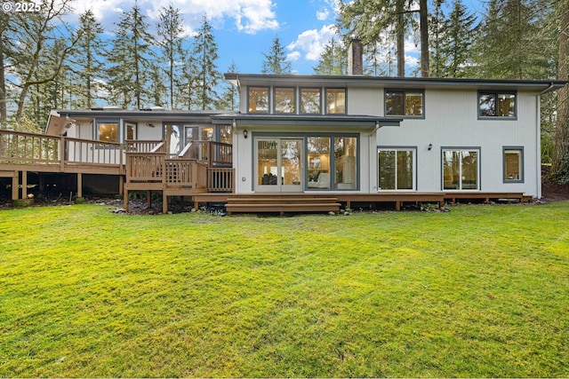 back of house with a lawn and a deck