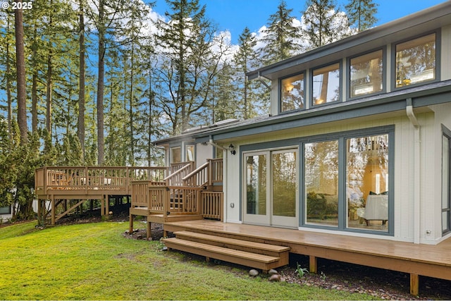 back of house with a wooden deck and a yard