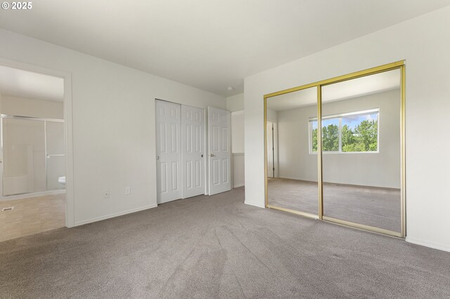 15629 NW Energia St, Portland, OR 97229 - unfurnished bedroom with two closets, carpet, and ensuite bathroom