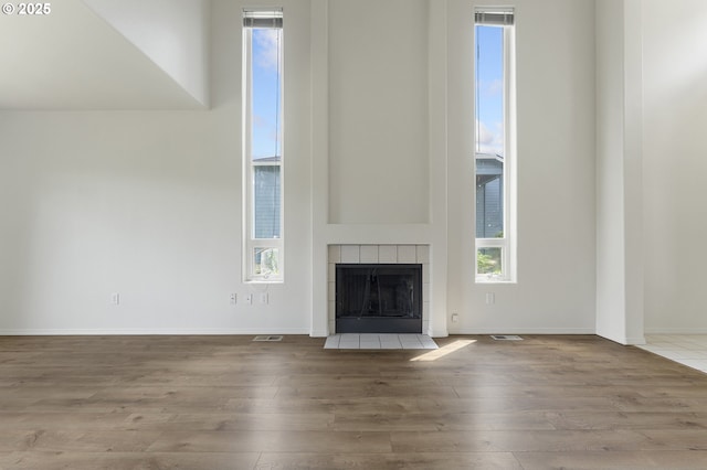 15629 NW Energia St, Portland, OR 97229 - unfurnished living room featuring wood finished floors and a tile fireplace