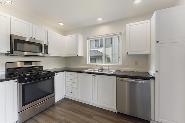15629 NW Energia St, Portland, OR 97229 - kitchen featuring stainless steel appliances, dark countertops, white cabinets, recessed lighting, and dark wood-type flooring