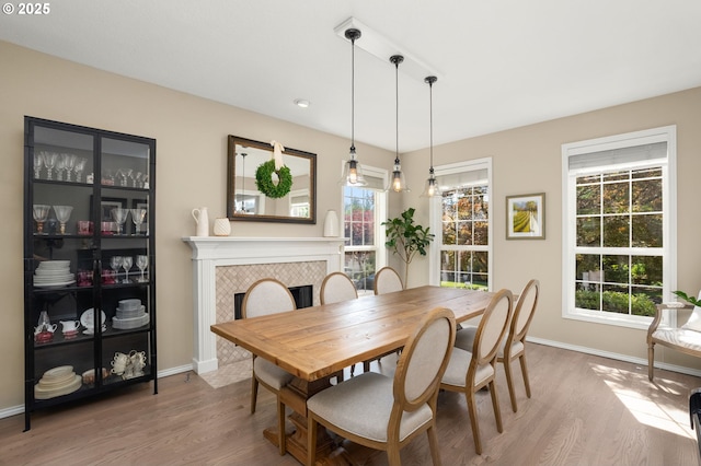 1648 NW 127th Ter, Portland, OR 97229 - dining room featuring wood finished floors and a tile fireplace
