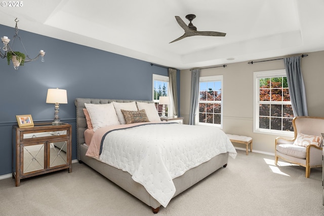 1648 NW 127th Ter, Portland, OR 97229 - bedroom featuring a tray ceiling, multiple windows, and carpet floors