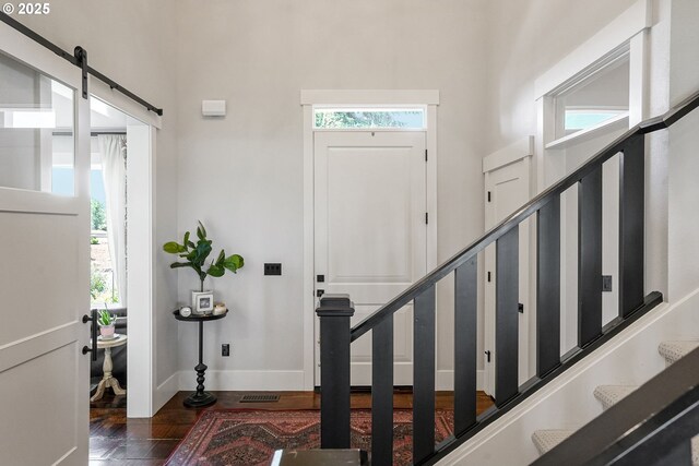 4040 Victor Point Rd NE, Silverton, OR 97381 - entrance foyer with wood finished floors, stairs, a towering ceiling, baseboards, and a barn door