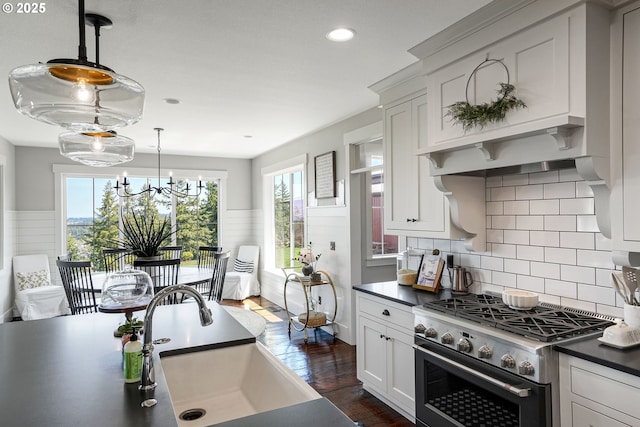 4040 Victor Point Rd NE, Silverton, OR 97381 - kitchen featuring high end stove, a sink, dark countertops, white cabinets, and dark wood finished floors