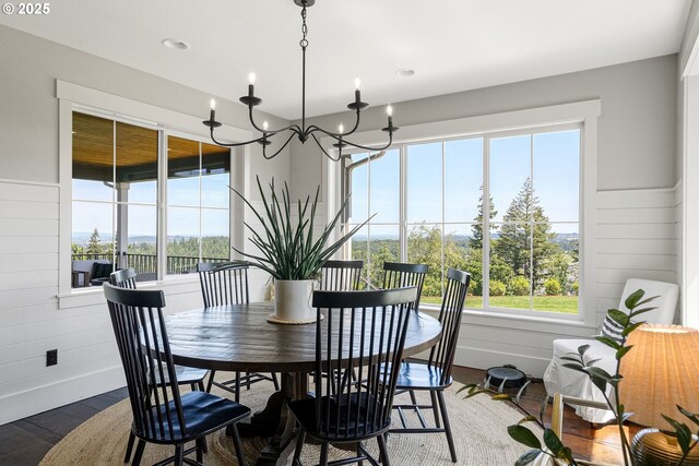 4040 Victor Point Rd NE, Silverton, OR 97381 - dining area with wood finished floors, a chandelier, baseboards, and wooden walls