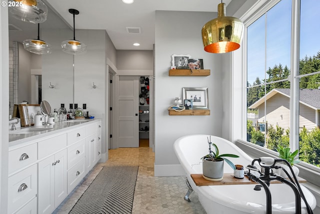 4040 Victor Point Rd NE, Silverton, OR 97381 - full bath with vanity, a freestanding tub, recessed lighting, a closet, and baseboards