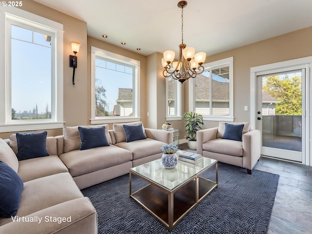 10193 SE Crescent Ridge Loop, Happy Valley, OR 97086 - living room featuring a chandelier, plenty of natural light, and stone tile flooring