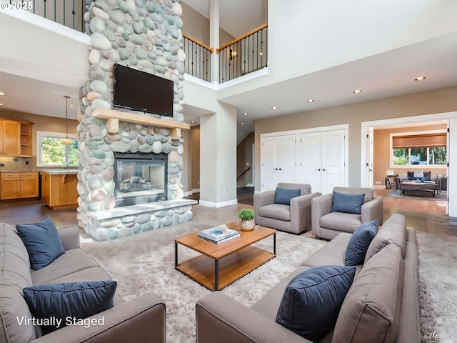 10193 SE Crescent Ridge Loop, Happy Valley, OR 97086 - living area with a towering ceiling, a stone fireplace, and recessed lighting