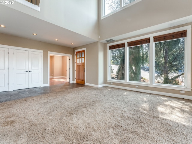 10193 SE Crescent Ridge Loop, Happy Valley, OR 97086 - unfurnished living room featuring carpet, recessed lighting, and a high ceiling