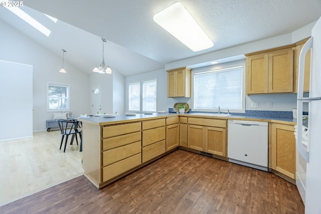 3618 Sterling Woods Dr, Eugene, OR 97408 - kitchen with white appliances, a skylight, dark wood-style flooring, light brown cabinets, and vaulted ceiling