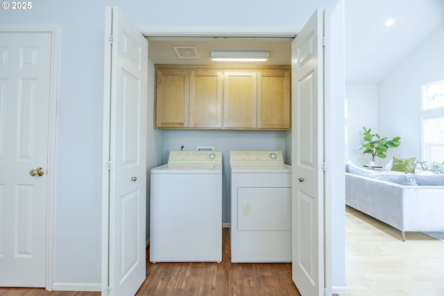 3618 Sterling Woods Dr, Eugene, OR 97408 - laundry room with washing machine and dryer, cabinet space, and light wood-style flooring