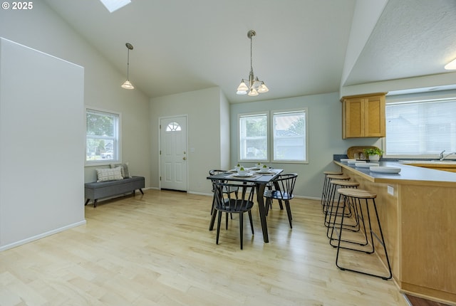 3618 Sterling Woods Dr, Eugene, OR 97408 - dining room with healthy amount of natural light, a chandelier, light wood-style flooring, and high vaulted ceiling