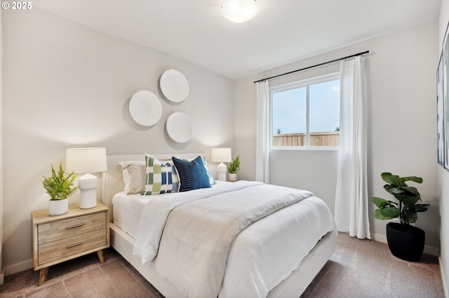 bedroom with carpet flooring and baseboards