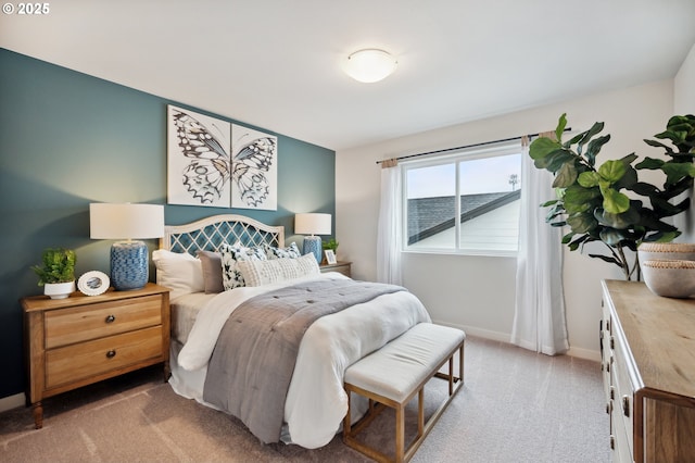 carpeted bedroom featuring baseboards