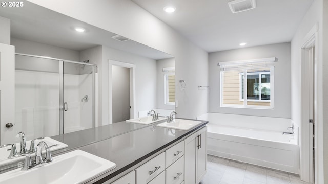 full bathroom featuring a sink, a garden tub, a stall shower, and visible vents