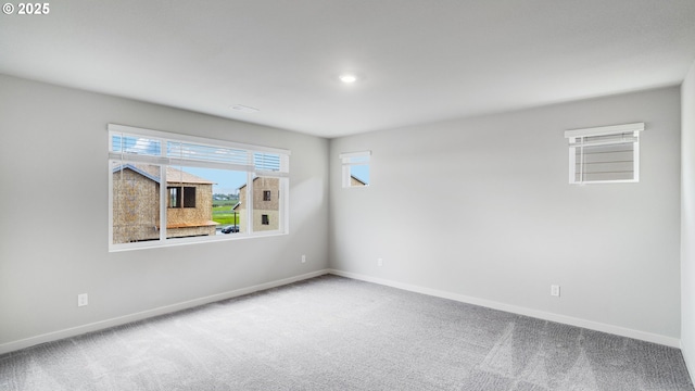 carpeted empty room featuring baseboards, plenty of natural light, and recessed lighting