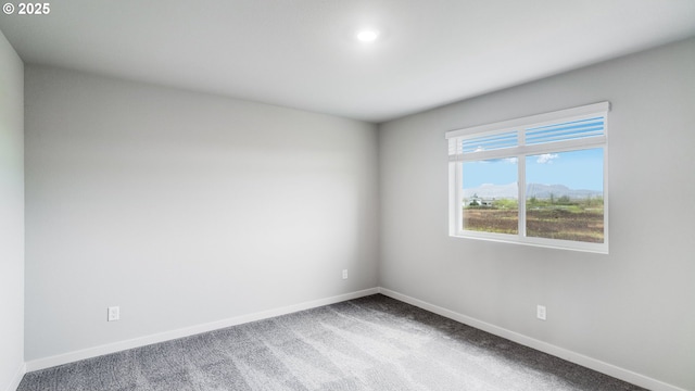 carpeted empty room with baseboards and recessed lighting