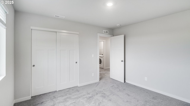 unfurnished bedroom with carpet, visible vents, and baseboards