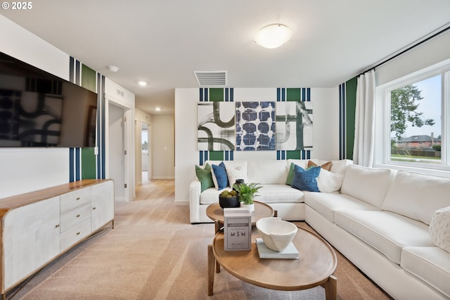 living area with baseboards, recessed lighting, visible vents, and light colored carpet