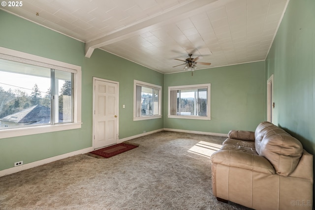 unfurnished living room featuring ceiling fan, beam ceiling, and carpet floors