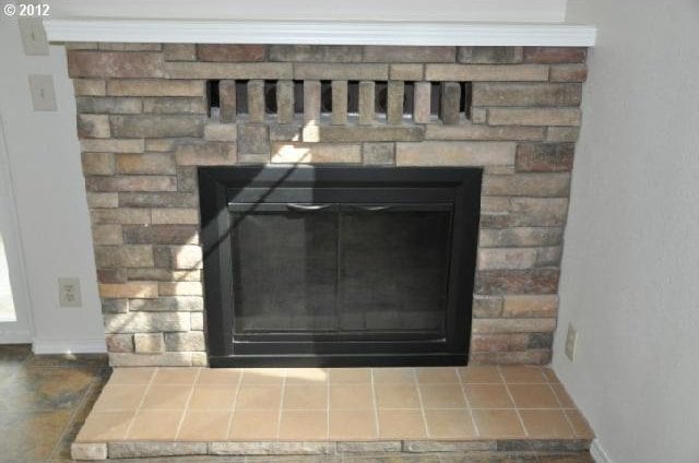 room details featuring a glass covered fireplace