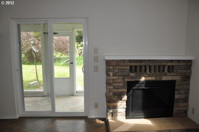 entryway with a fireplace and a healthy amount of sunlight