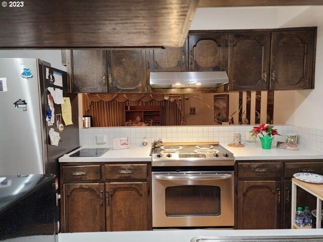 5723 NE Hazel Dell Ave Unit B, Vancouver, WA 98663 - kitchen featuring stainless steel appliances, extractor fan, decorative backsplash, and light countertops