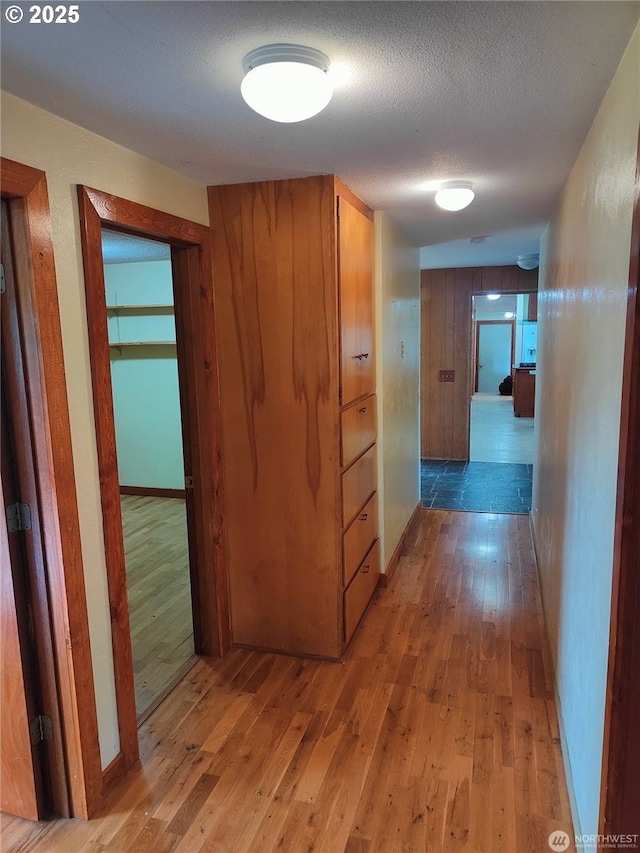 3420 Prill Rd, Centralia, WA 98531 - hall with light wood-style flooring, baseboards, and a textured ceiling