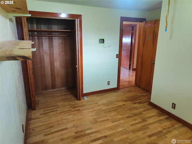 3420 Prill Rd, Centralia, WA 98531 - unfurnished bedroom with light wood-style floors, baseboards, and a closet