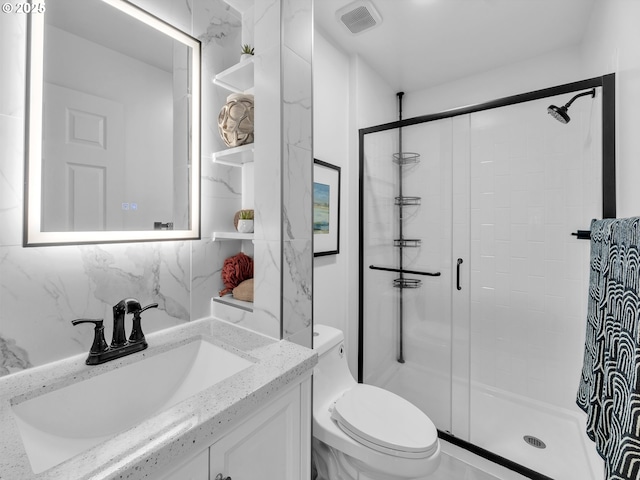 bathroom with a shower with door, vanity, tasteful backsplash, and toilet