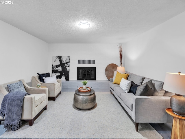 living room featuring a fireplace and a textured ceiling