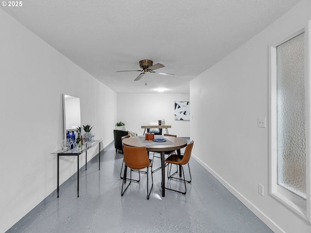 dining room featuring a textured ceiling and ceiling fan