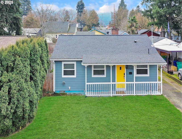 view of front of property with covered porch and a front lawn