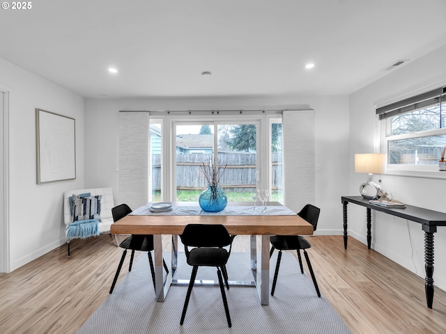 dining room featuring light hardwood / wood-style floors and a healthy amount of sunlight