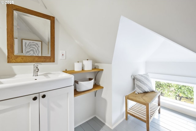 bathroom featuring vanity and vaulted ceiling