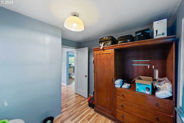 bedroom featuring light wood-style flooring and baseboards